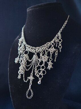 Asymmetrical silver statement necklace with a small silver chain